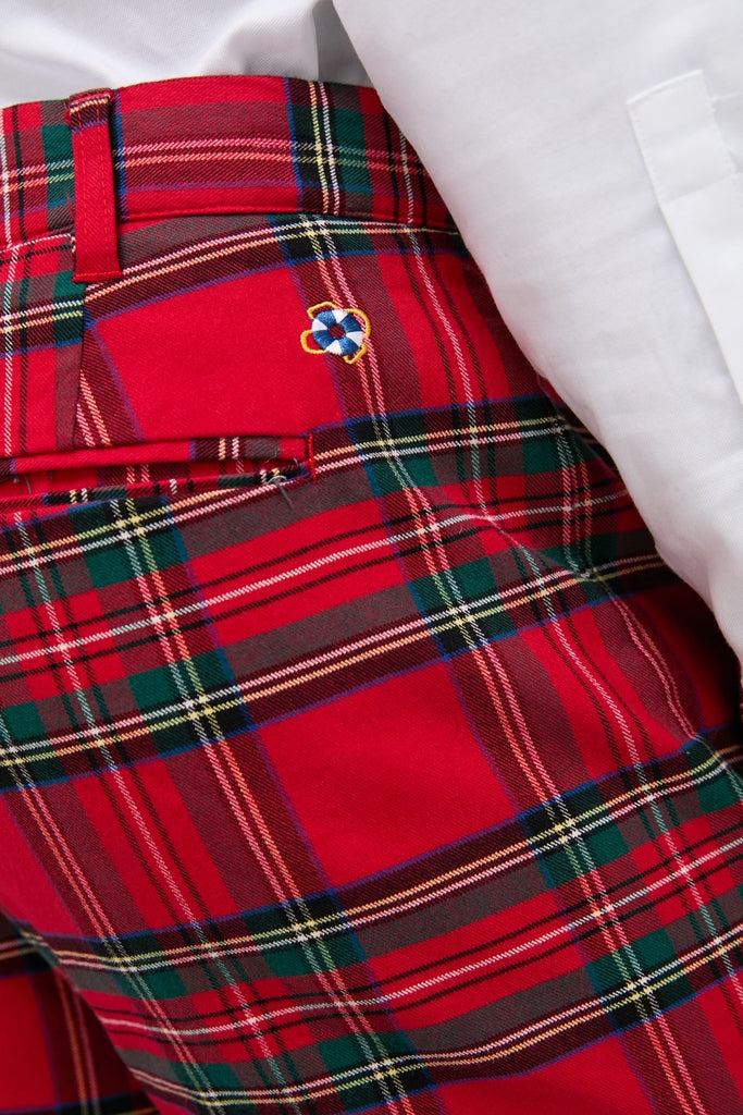 Royal Stewart Tartan Stretch Twill Harbor Pants featuring a classic tartan print; effortlessly stylish, high-end design with embroidered logo above back pocket, paired with a tucked white shirt.