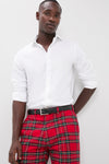 Young man wearing Royal Stewart Tartan Stretch Twill Harbor Pants, showcasing classic, effortless style with rolled-up sleeves, embodying high-end, fun coastal fashion.