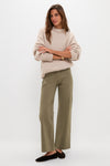 Model wearing Olive Sailor Pant with patch pockets, styled effortlessly with a rib-knit sweater and ballet flats, showcasing a classic, high-end, and fun minimalist look.