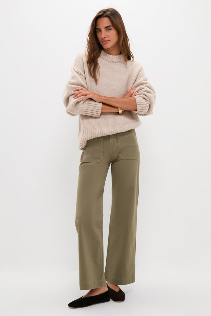 Model wearing Olive Sailor Pant with patch pockets, styled effortlessly with a rib-knit sweater and ballet flats, showcasing a classic, high-end, and fun minimalist look.