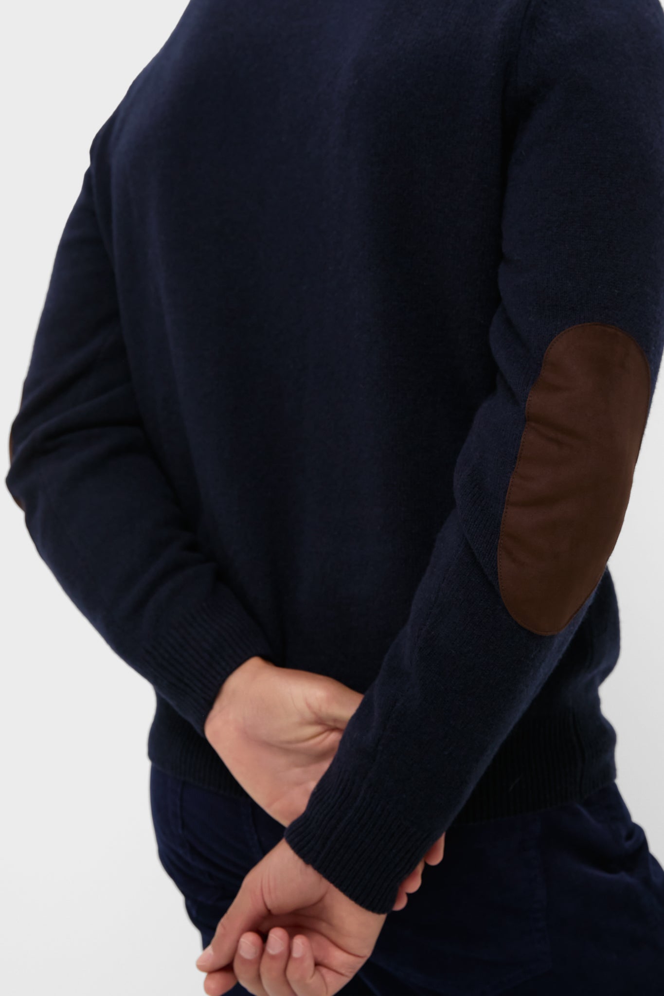 Back view of Navy Essential Patch Half Zip Knitted Jumper, showcasing classic leather elbow patches and ribbed cuffs, embodying effortless style and high-end craftsmanship.