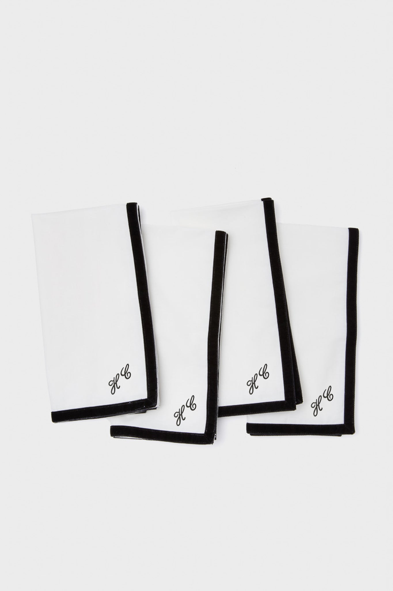 Black Velvet Trim Napkins Set of 4: Classic white cotton napkins with effortless black border and HC monogram. Perfect for adding a fun, high-end touch to any table setting.