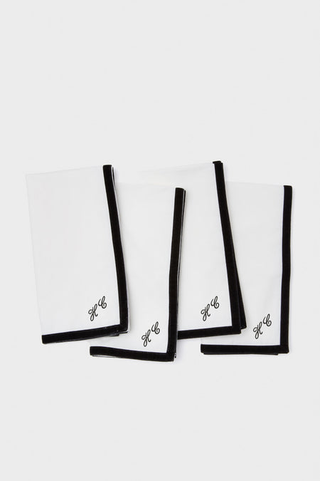 Black Velvet Trim Napkins Set of 4: Classic white cotton napkins with effortless black border and HC monogram. Perfect for adding a fun, high-end touch to any table setting.