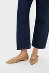 Gold Gracie Pointed Toe Crochet Flats worn with dark jeans, showcasing classic, effortless style. Handwoven vegan leather from Italy; perfect for fun, high-end looks.