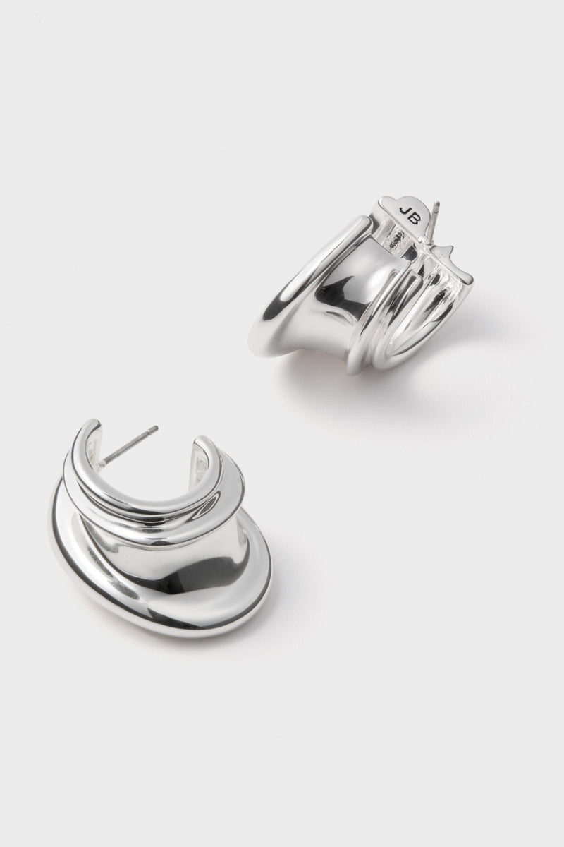 High Polish Silver Leona Hoops with wavy sculptural design, showcasing a classic, effortless style. Perfect for fun, high-end looks; features post back and “JB” hallmark.