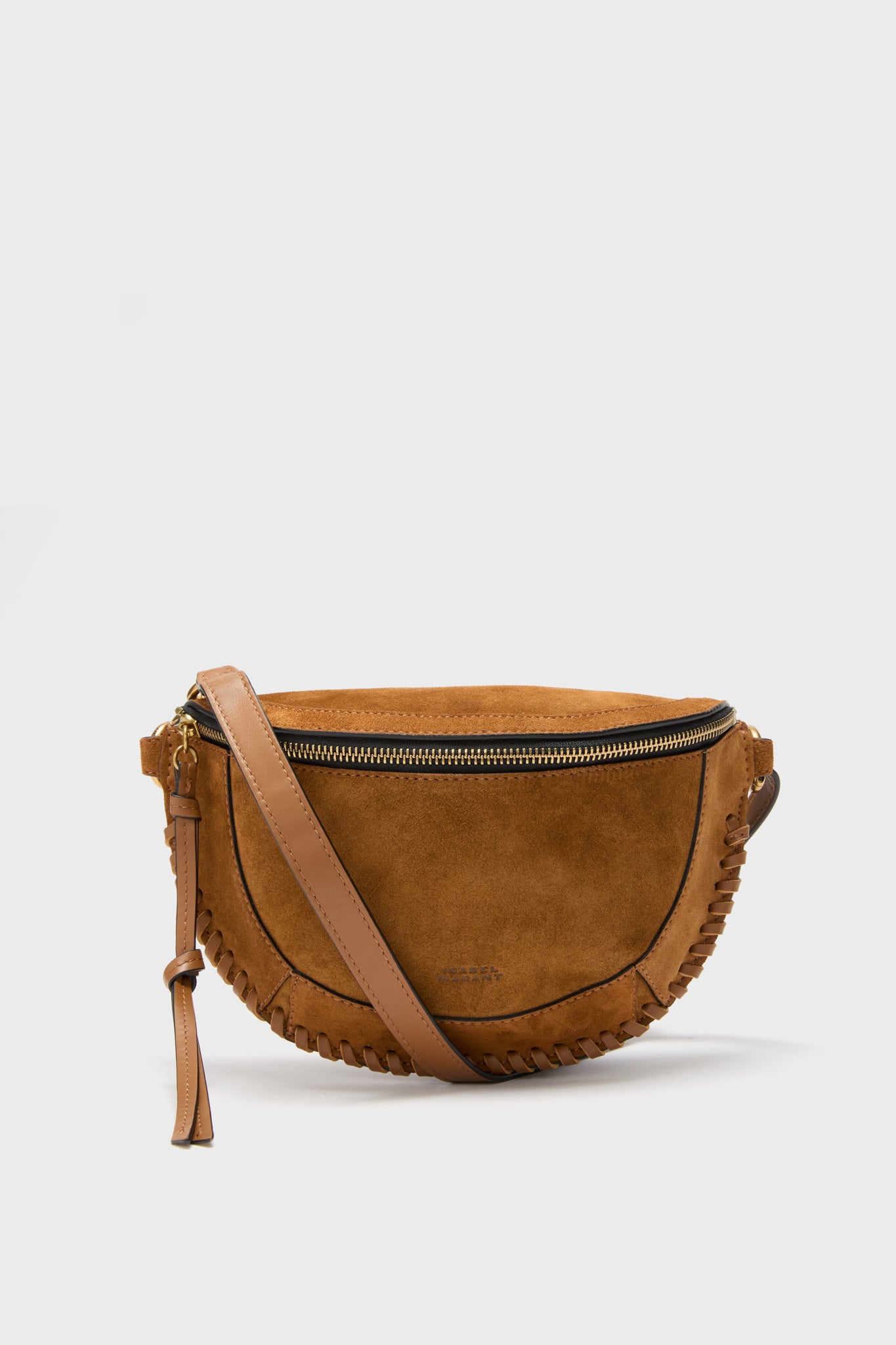 Isabel Marant brown suede crossbody bag with zipper closure, decorative edge stitching, and adjustable leather strap. Features a chic crescent shape inspired by the brand’s iconic Cognac suede design.
