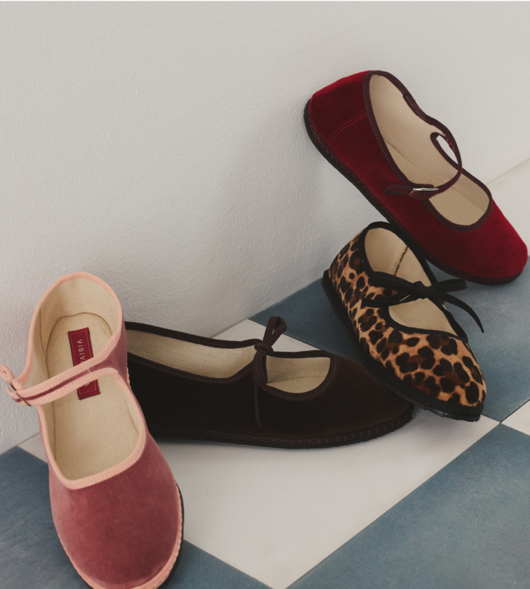 Four different colored ballet flats one pink, one brown, one cheetah, and one red. 