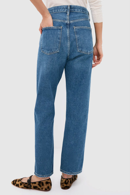 Person wearing Bounty Mid Rise Loose Fit 90's Jean, featuring classic high-waisted, straight-leg design, styled effortlessly with leopard-print flats for a fun, high-end look.