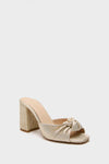 Gold Pleated Blake Heels: Classic mule-style shoe with a shimmery finish, featuring an effortless square toe, knotted pleated vamp, and a fun, high-end chunky block heel.