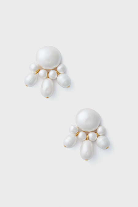 A pair of statement earrings from Tuckernuck Jewelry, in white with elegant gold-plated accents.