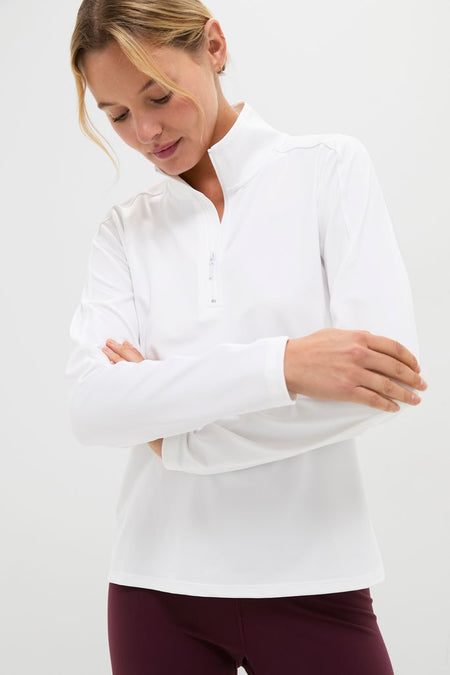 Model in White Performance Jersey Carver Quarter Zip Tee with mock collar and quarter-zip, paired with leggings, showcasing a classic, effortless, and high-end style perfect for active wear.