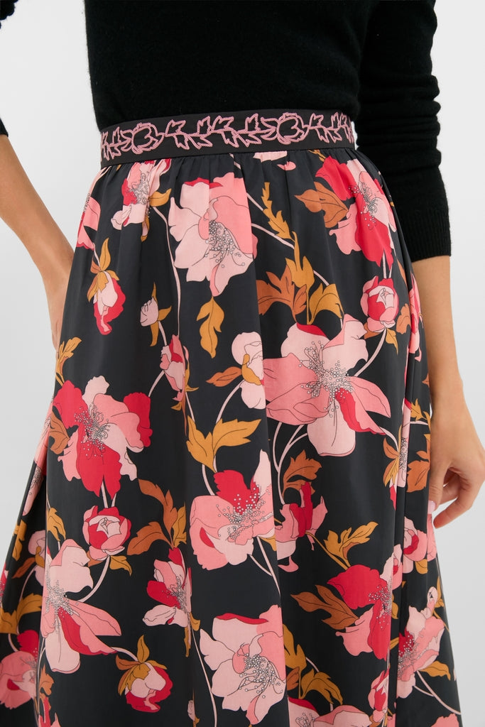 The Black & Shades of Pink Floral Embroidered Sia Maxi Skirt showcases a classic A-line silhouette with bold floral prints and an effortless, high-end elasticated waistband.