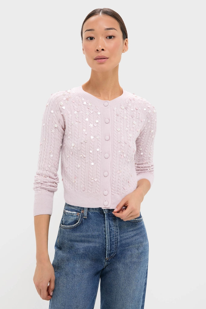 Model wearing the Blush Pink Gilberte Embroidered Cardigan, a classic, effortless piece with iridescent sequins, paired with high-waisted jeans for a fun, high-end look.
