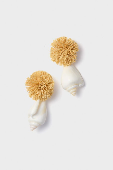 Shell and Pom Elaine Earrings feature classic drop-style design with natural raffia pom-poms and glossy white seashells, offering an effortless, high-end accessory for fun, confident style.