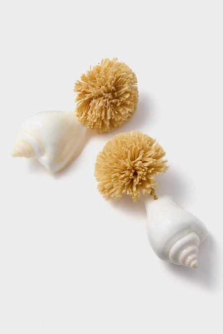 Classic Shell and Pom Elaine Earrings feature ceramic shell handles with natural-fiber bristle heads, offering an effortless, fun, and high-end aesthetic.