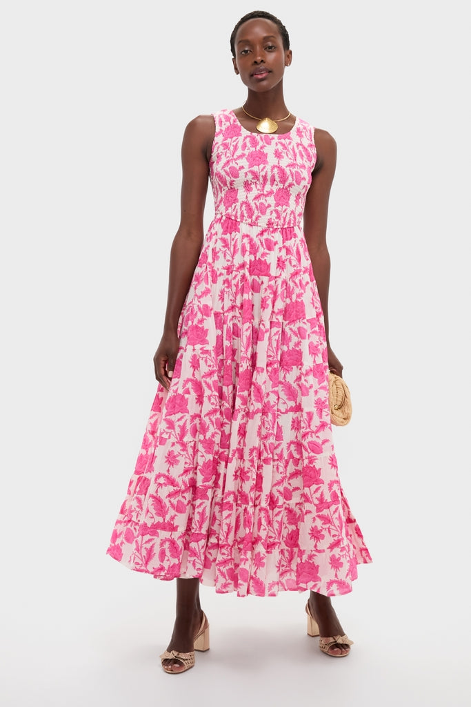 Woman models a classic sleeveless maxi dress with bright pink floral print, accessorized with a Gold Clam Shell Lillian Necklace, exuding effortless, high-end style.