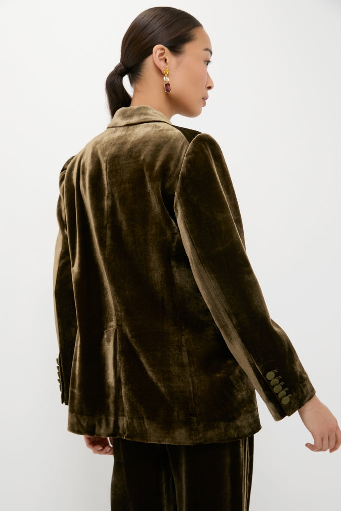Woman in an Olive Velvet Diana Blazer, showcasing a classic, high-end style with effortless elegance, accessorized with drop earrings, embodying Tuckernuck's fun and confident fashion ethos.