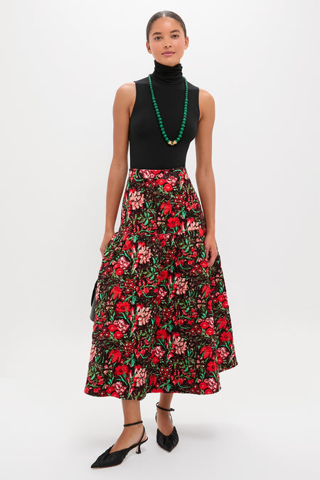 Woman wearing the Malachite Double Strand Celine Necklace, styled effortlessly with a classic black bodysuit and floral skirt, capturing a fun, high-end, and confident look.