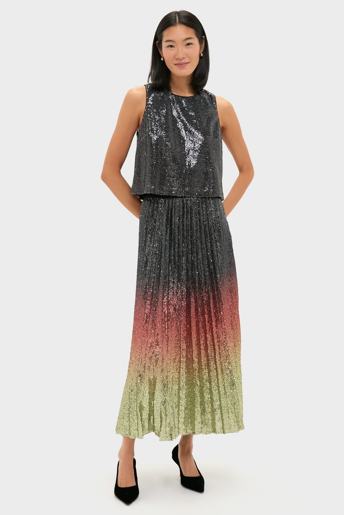 Young woman in a classic, high-end Ombre Sequin Bleeker Maxi Skirt, effortlessly styled with a loose black sequin top, exuding fun and confidence.