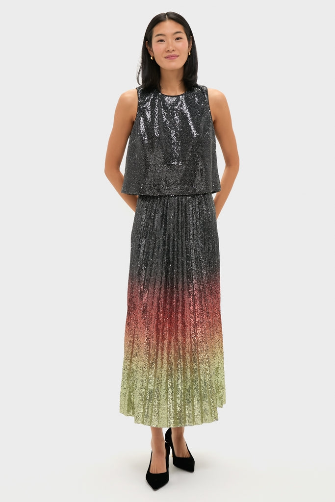 Woman in a classic, high-end Charcoal Sequin Bowery Top with a sleeveless high-neck bodice and an effortless ombré sequin skirt, embodying fun sophistication.