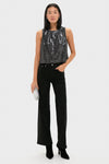 Model wearing Charcoal Sequin Bowery Top, a classic, effortless, high-end sleeveless piece, paired with black pants and a fun rhinestone clutch for a confident look.