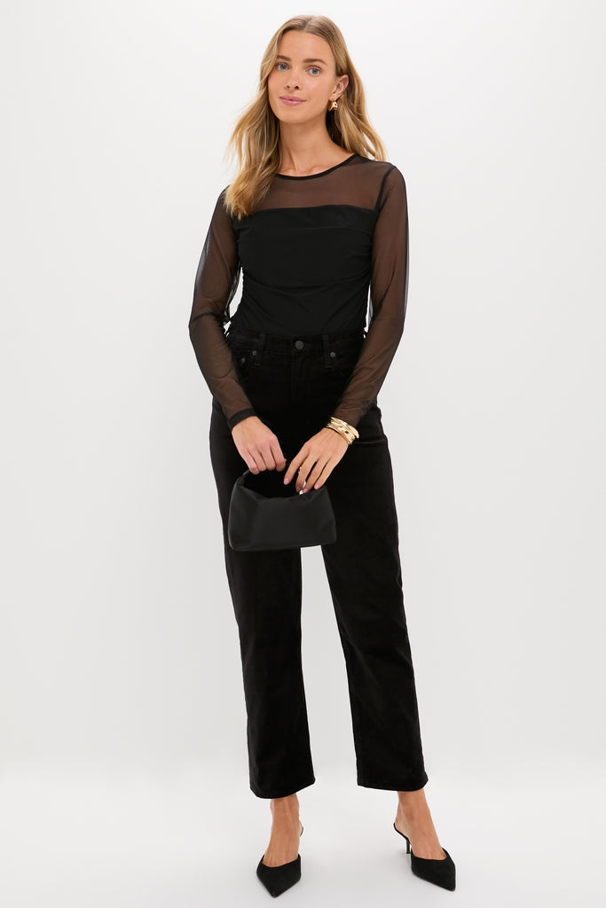 Woman in an all-black outfit showcasing classic, high-end style. Features High Polish Gold Mega Lennon Bangle, adding effortless elegance and fun to her look.