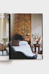 Interiors: Styled by Mieke Ten Hav showcases a classic, high-end bedroom with an effortlessly chic dark-green bed, botanical room divider, and fun floral accents.