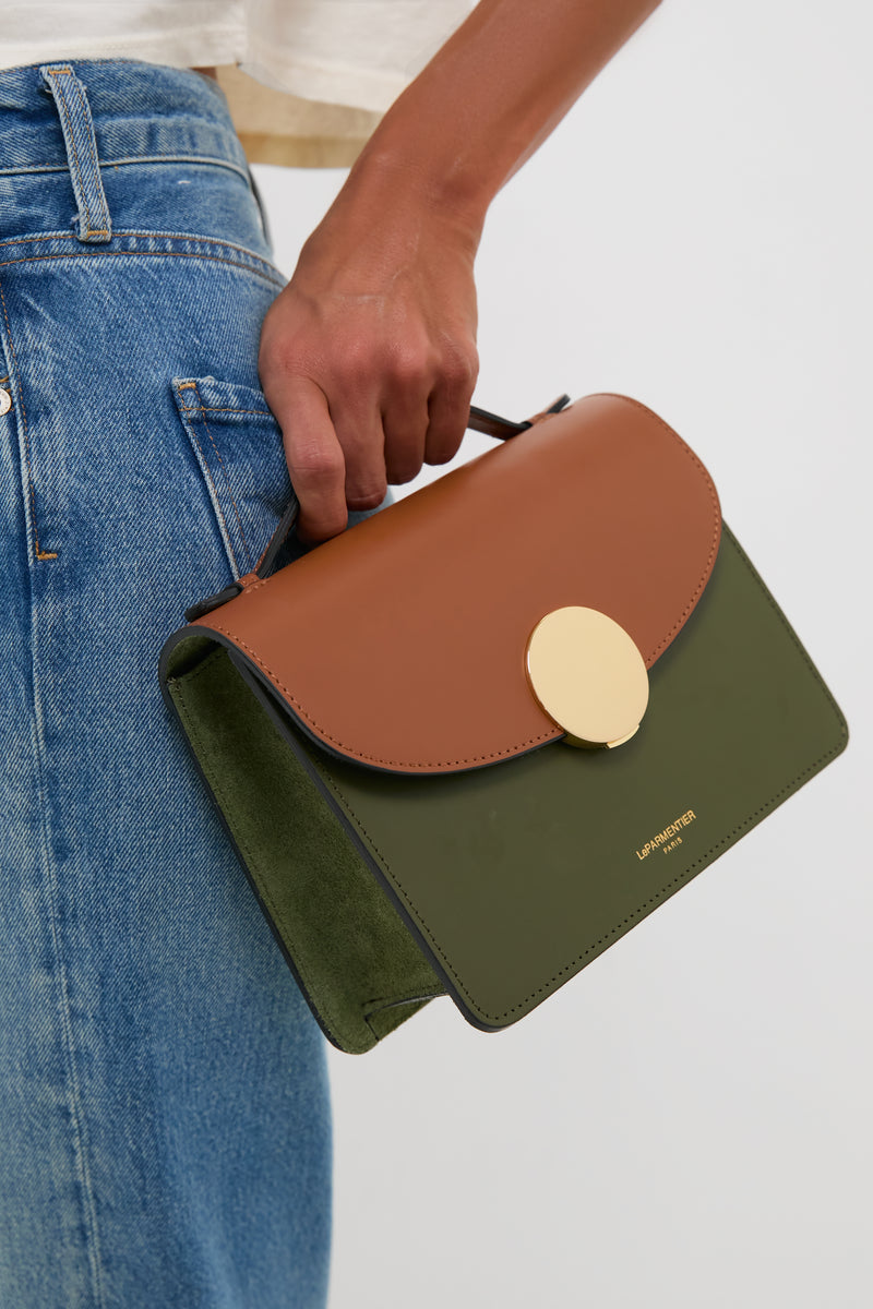 Caramel and Military Green Ondina Medium Color-Block Bag with gold clasp, leather handle, and suede lining, held effortlessly with fun, classic style. Perfect for high-end versatility.