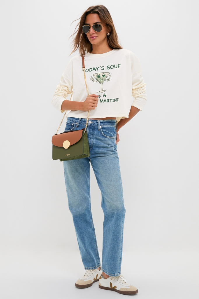 Woman in a classic, fun Martini Soup Crop Long Sleeve Tee by ASKK NY, paired with effortless jeans and accessories, embodying high-end casual style.