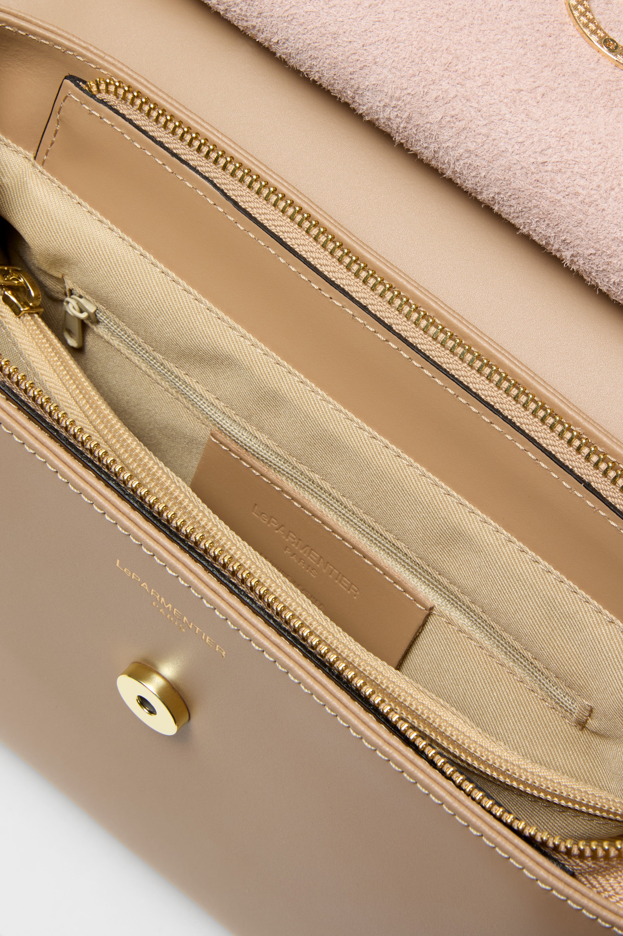 Nude Thais Satchel Bag, a classic, high-end accessory featuring a suede flap, gold-tone hardware, and organized compartments. Effortless luxury for a fun, confident style.