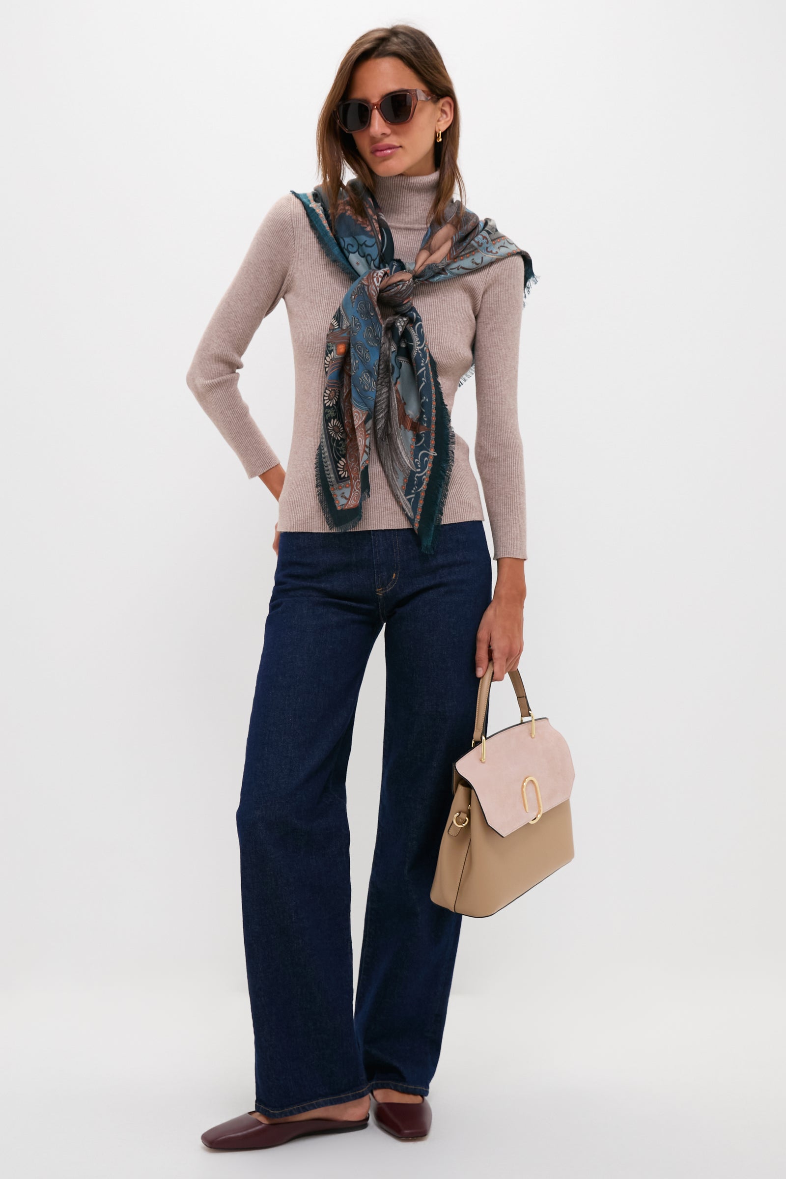 Woman models classic, high-end Nude Thais Satchel Bag, showcasing its effortless style; structured design with dual textures, gold hardware, and versatile handle options.