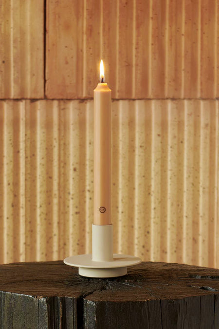 Cedar Scented Taper Candle, lit in a classic holder atop a wooden block, exudes effortless elegance. Perfect for high-end, fun tablescapes.