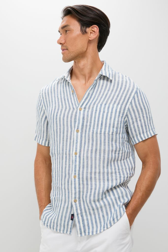 Model in an Ivory Stripe Short Sleeve Palma Linen Shirt with a classic, effortless style, featuring a button-front, chest pocket, and tailored fit, perfect for a high-end, fun summer look.