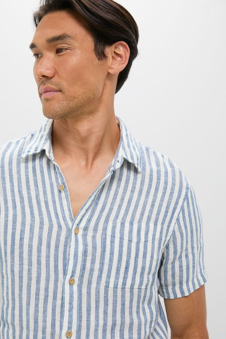 Man wearing classic Ivory Stripe Short Sleeve Palma Linen Shirt with vertical stripes; features include a front button placket and chest pocket for an effortless, high-end summer style.