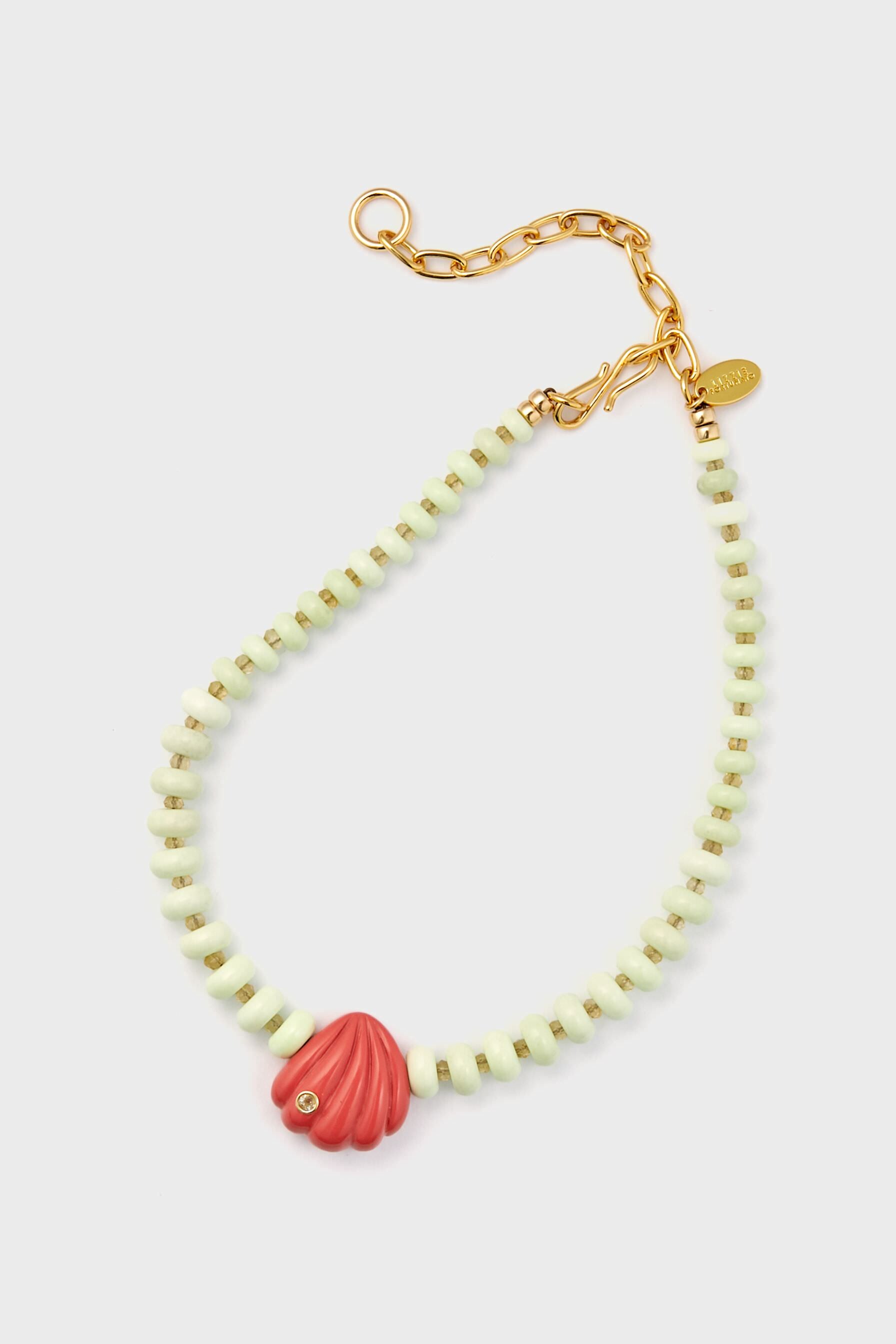 Lizzie Fortunato beaded necklace with pale green lemon chrysoprase beads, a gold-plated collar and clasp, and a pink shell-shaped pendant with an embedded gem.