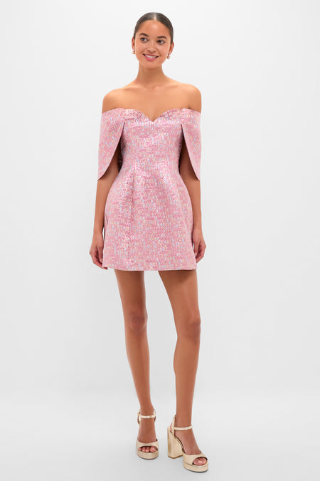 Model wears the Pink Multi Jacquard Off-the-Shoulder Kara Midi Dress, featuring a sweetheart neckline and sculpted sleeves, paired with gold platform sandals for an effortless, high-end look.