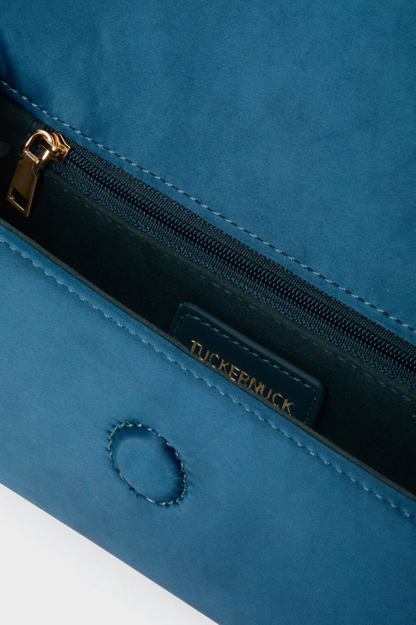 Peacock Blue Satin Gabrielle Clutch with braided tassel, gold zipper, and magnetic closure, offering a classic, effortless accessory for high-end, fun occasions.