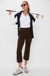 Woman in classic, high-end Tuckernuck attire: Petite Chocolate Brown Compression September Pant, perfect for an effortless, fun style on the golf course or at the office.