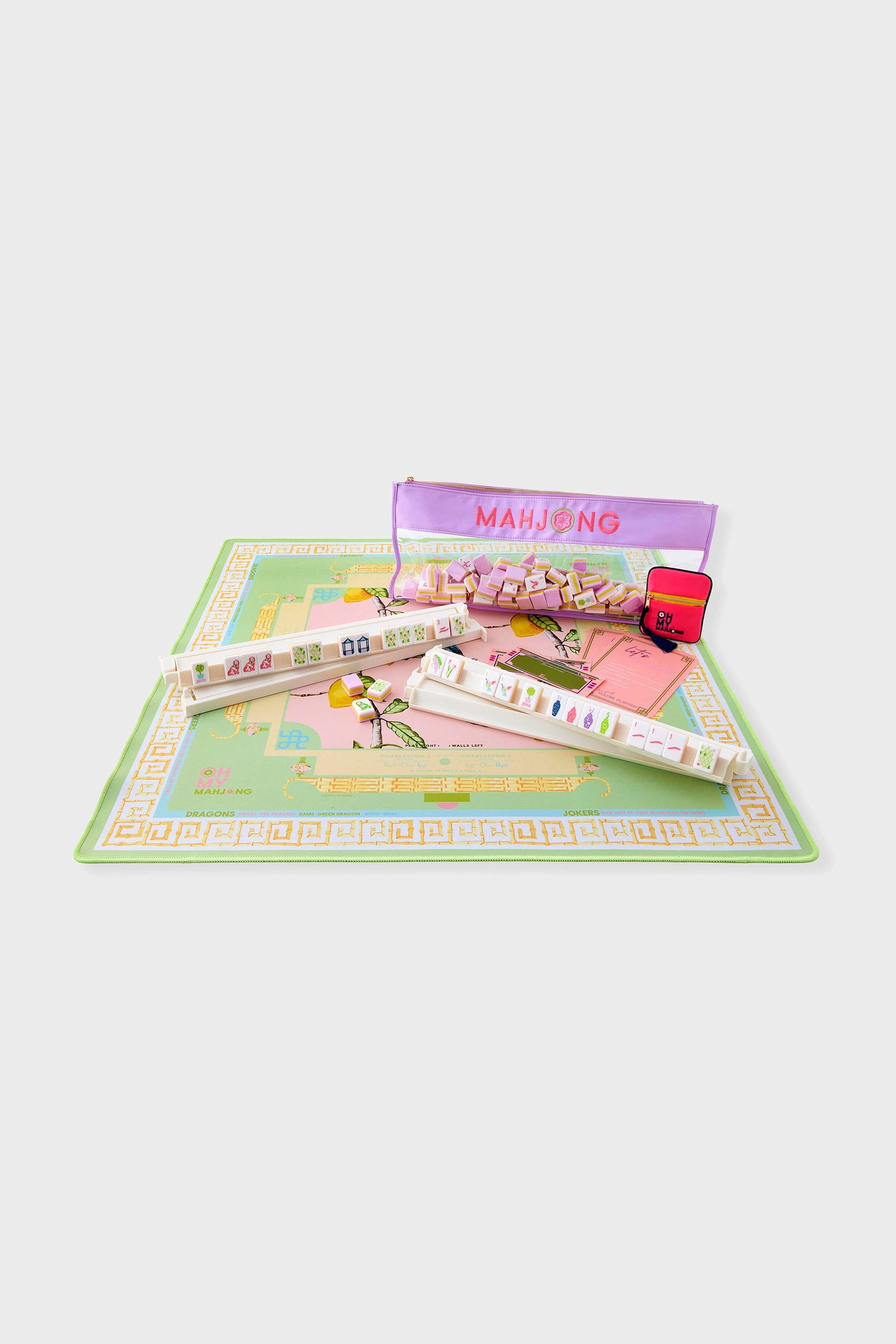 Citrus Songbird Playing Mat with pastel mahjong set, featuring classic ivory tiles, purple pouch, and red carrying case for a fun, high-end gaming experience.
