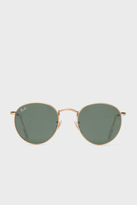 A pair of Ray-Ban round sunglasses with a gold frame and green-tinted lenses is displayed.