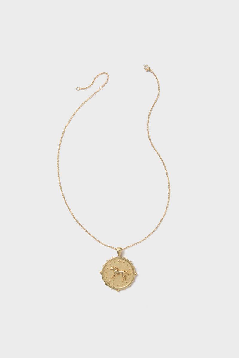 The Jane Win 14k gold-plated coin pendant necklace features a fine chain and a round engraved pendant with a raised sun and moon design.