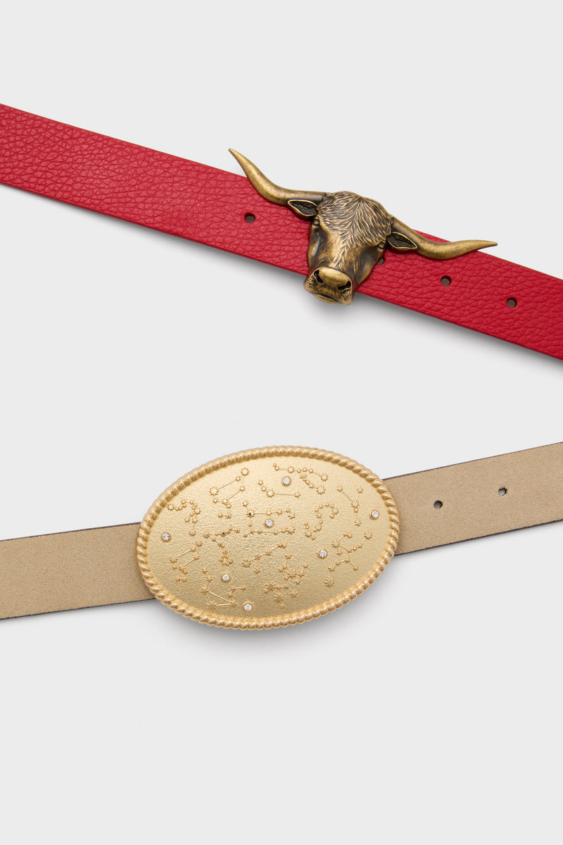 Two fashion belts: a classic red leather-look belt with an antique-brass bull’s-head buckle and a timeless beige belt featuring a gold-tone constellation-embossed buckle for effortless style.