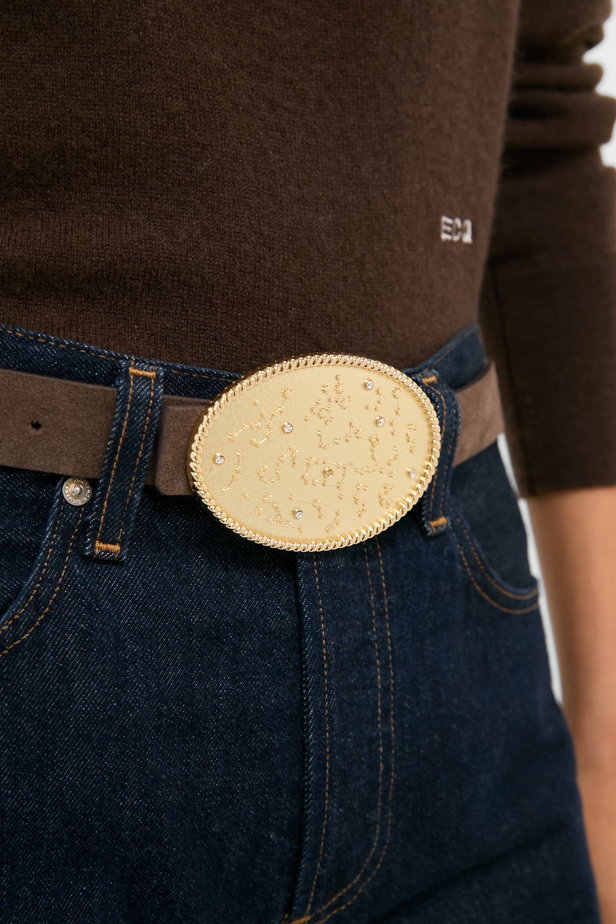 Gold Celeste Buckle—a classic, high-end accessory featuring a textured gold oval design with crystal stars, effortlessly elevating any outfit with fun sophistication.