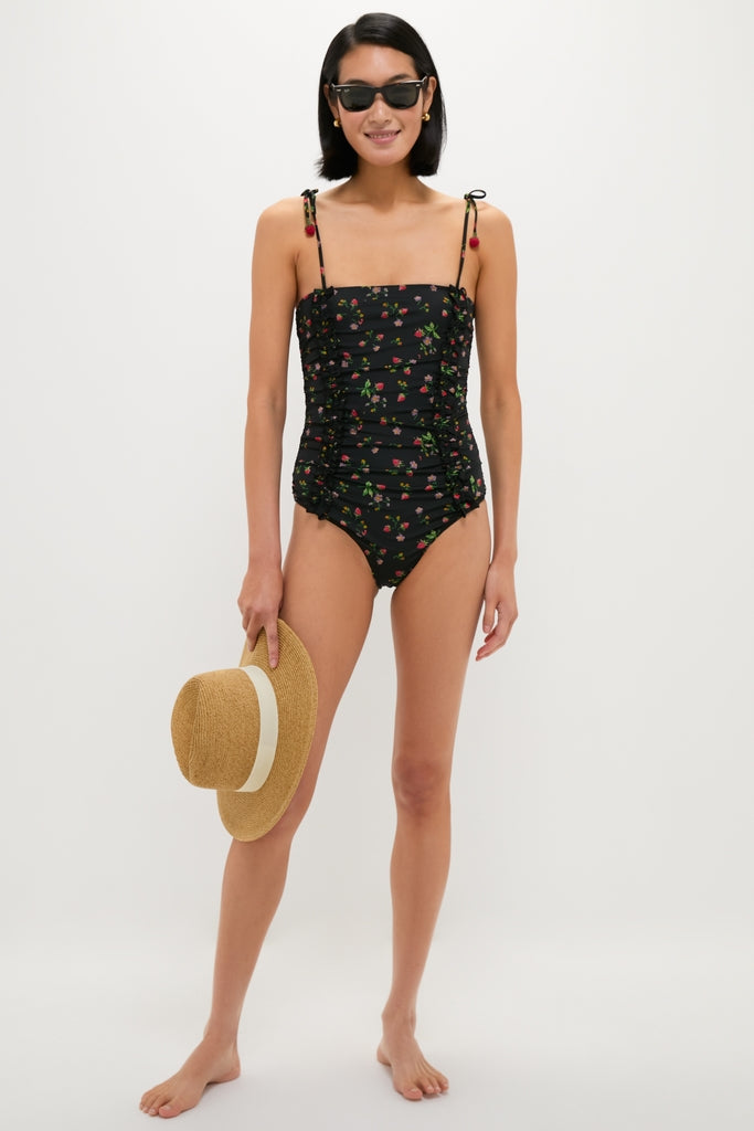 Woman holding the Exclusive Ivory Wide Brim Sun Hat, a classic, effortless, high-end accessory with ribbon detail, perfect for fun, sunny days.