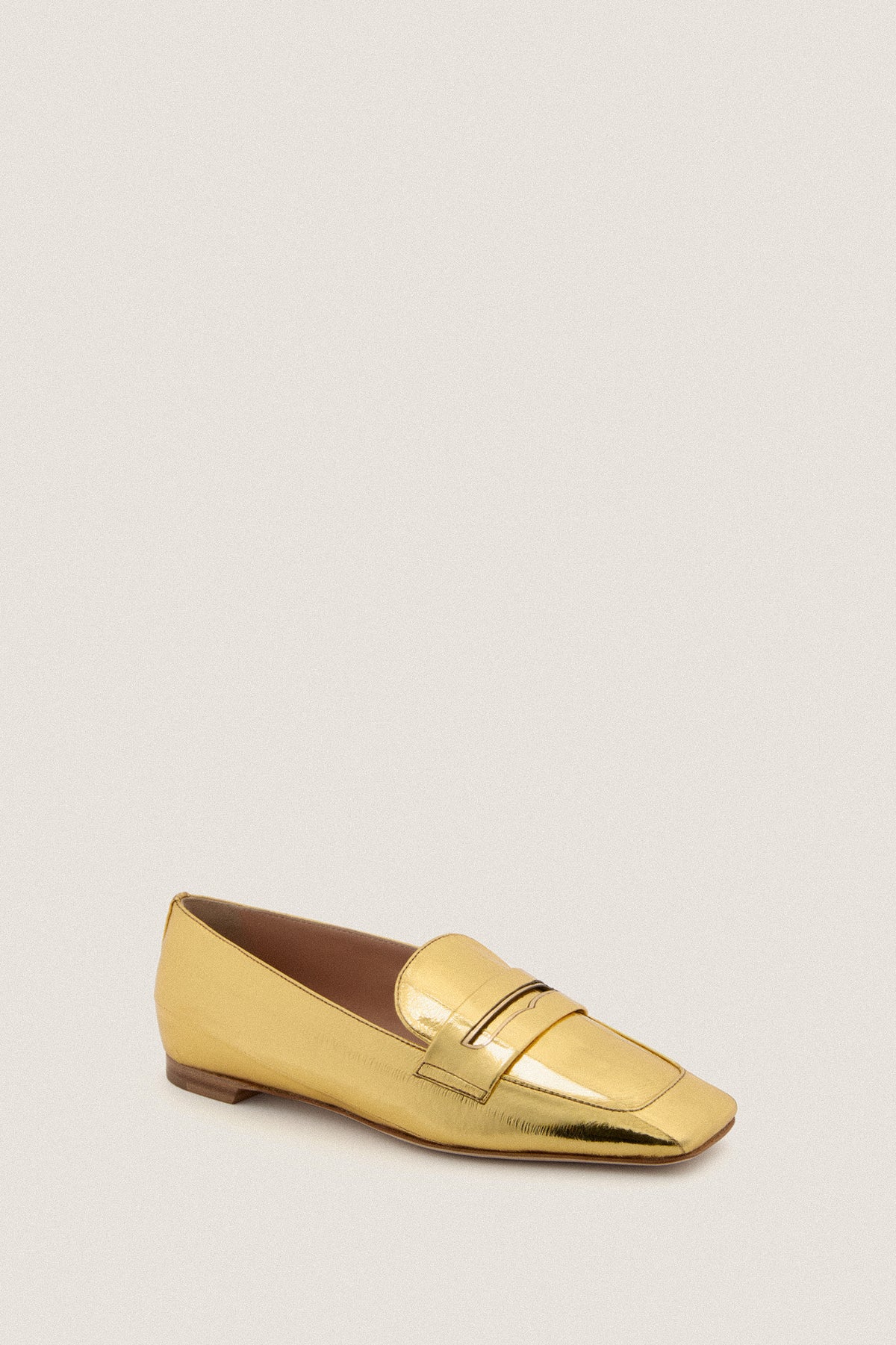 Gold Eel Doublet Loafers in metallic-gold finish feature a classic penny loafer design, square toe, low heel; exuding effortless, high-end style with a fun twist.