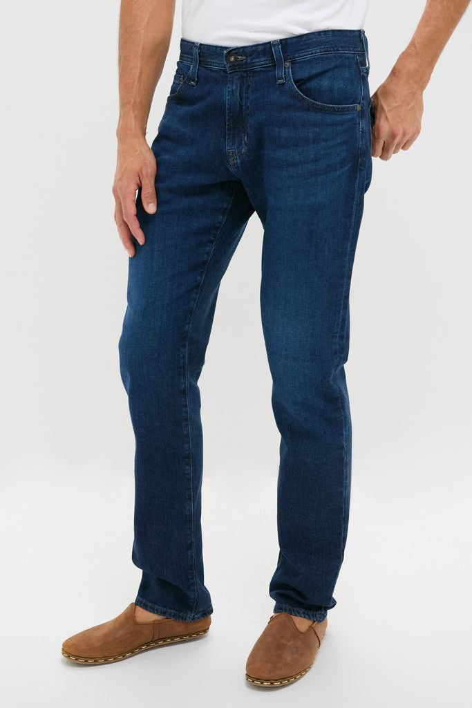 The Graduate in Crusade Wash Denim (34 Inseam), classic straight-leg jeans paired with brown loafers, embodying an effortless, high-end style for fun and versatile wear.