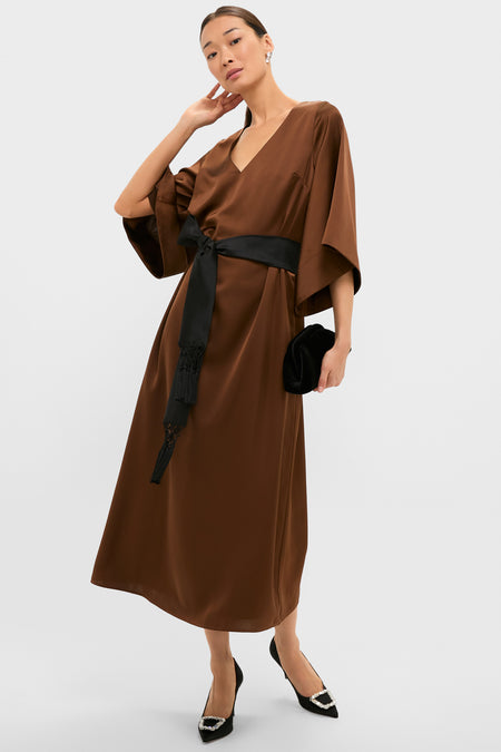 Woman wearing a classic, chocolate brown midi dress, styled with Black Sophia Heels featuring jeweled buckles; an effortless, high-end look, perfect for fun, confident outings.