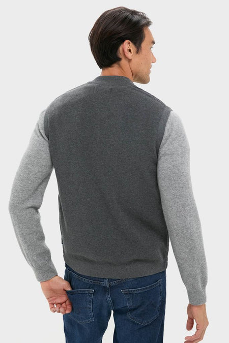 Man showcasing a classic, high-end Mid Gray Essential Gilet with a stand collar and quilted front, embodying an effortless, fun style against a light backdrop.