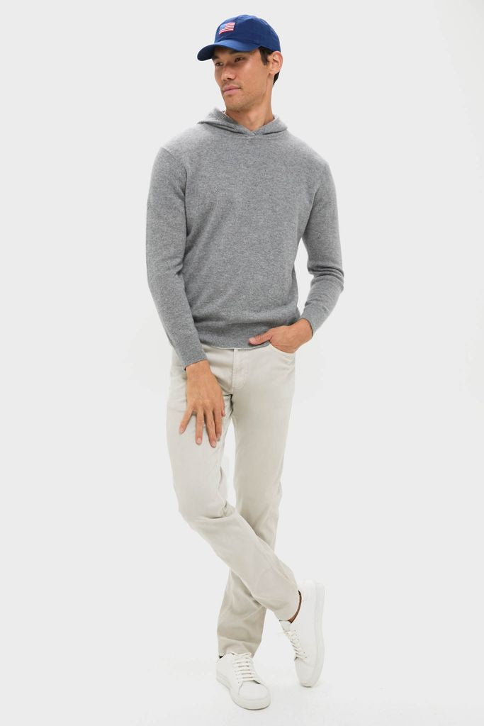 Man wearing Navy American Flag Needlepoint Hat, featuring a classic flag motif on a fine-knit hoodie outfit. This high-end, adjustable cotton twill accessory adds effortless, fun style.