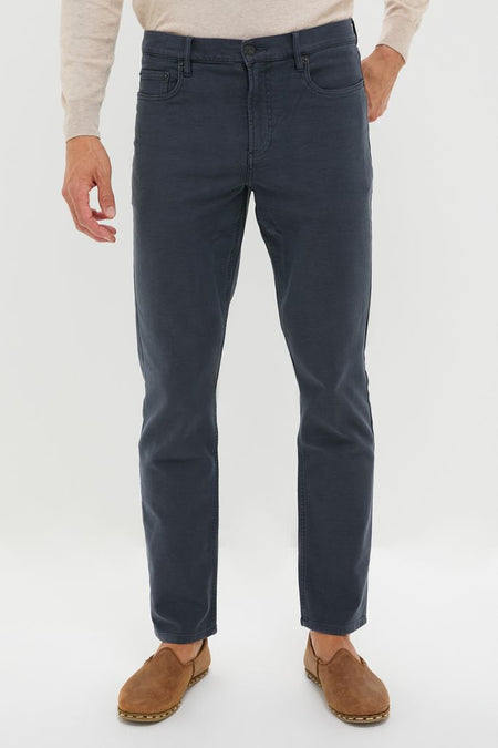 Navy Stretch Terry 5 Pocket trousers paired with light suede slip-ons, showcasing a classic, effortless style. Ideal for high-end, fun transitions between casual and dressy looks.